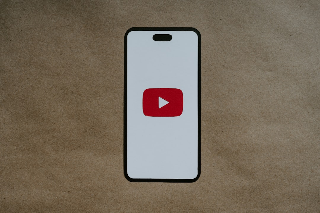 a-white-phone-with-a-red-youtube-logo-on-it-4t-faurr0o8