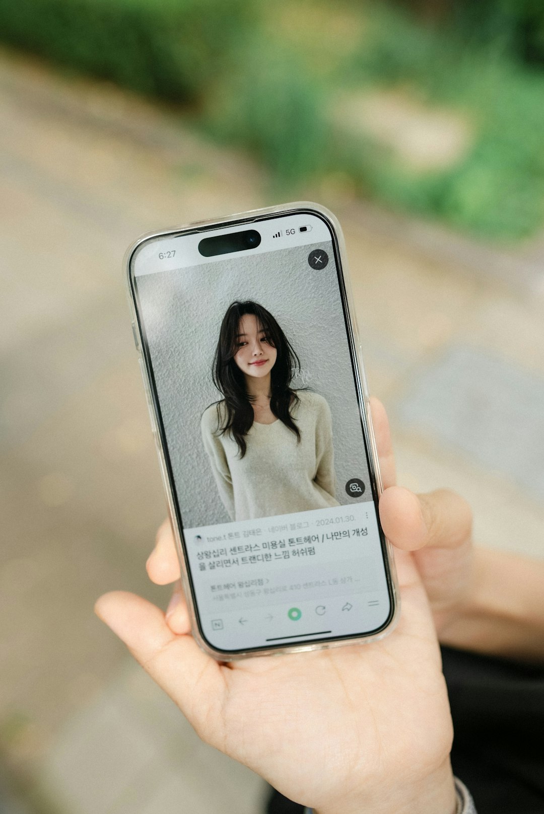 about-us-02 a-person-holding-a-cell-phone-with-a-picture-of-a-woman-hp0ppayeqnw